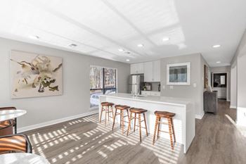 A kitchen with a bar and stools